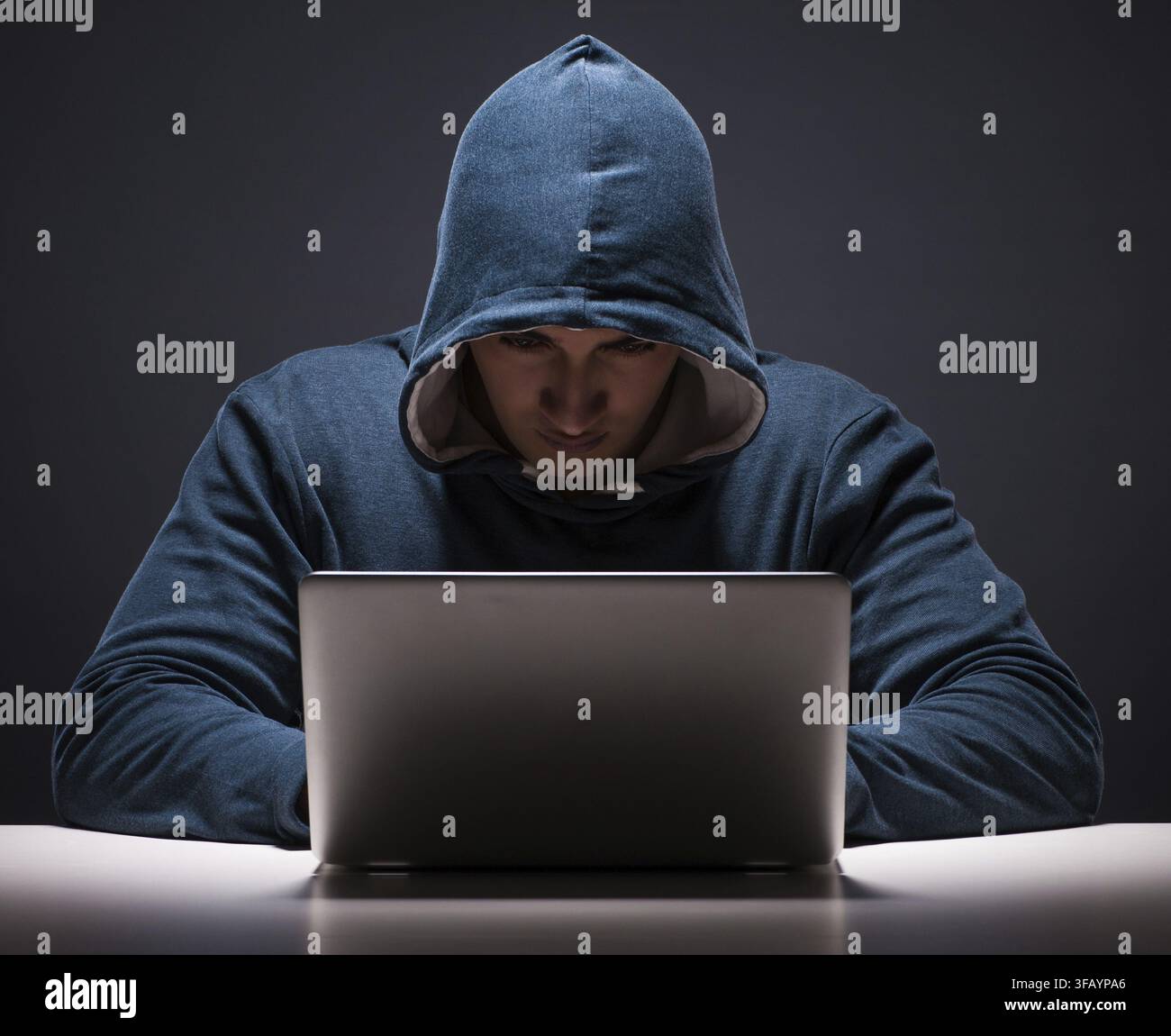 The computer hacker works in a dark room Stock Photo