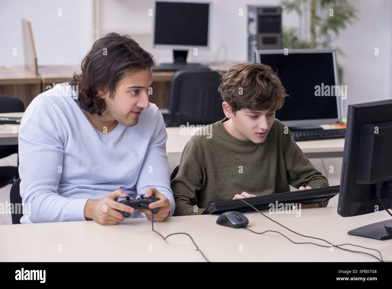 Father and son play computer games Stock Photo