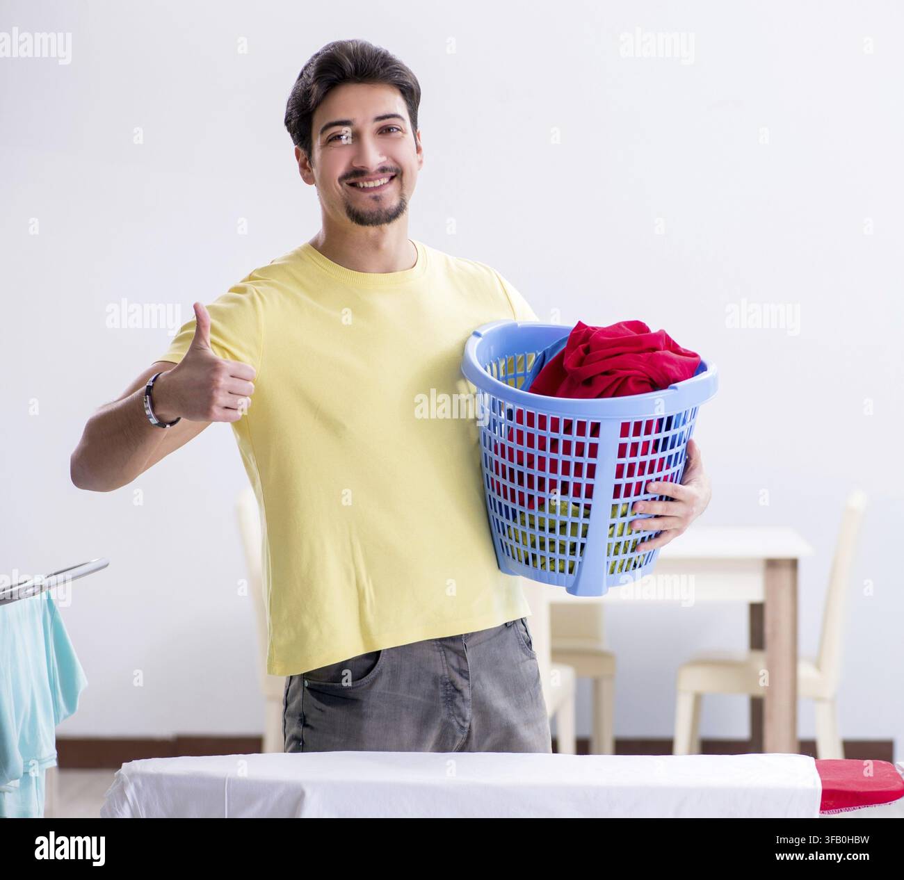 The handsome man doing laundry at home Stock Photo