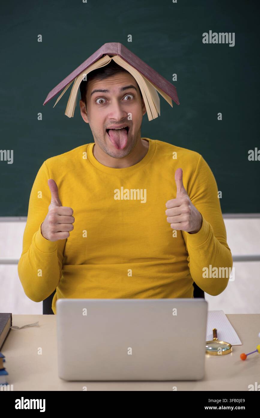 Young student sitting in classroom Stock Photo