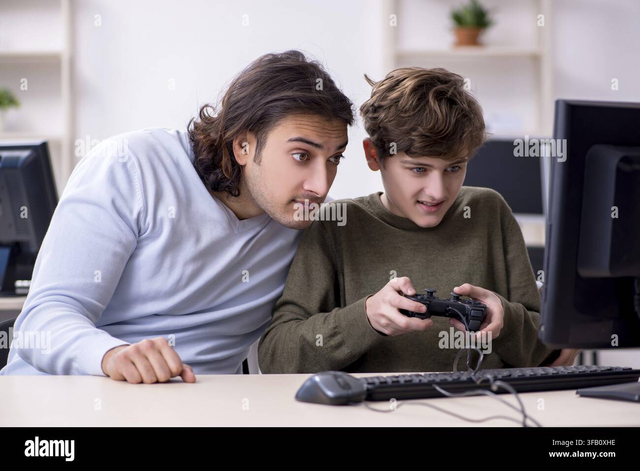 Father and son play computer games Stock Photo