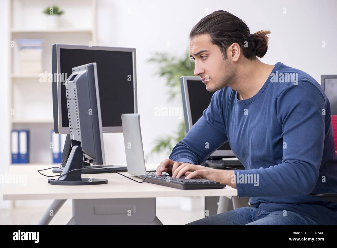 Young IT specialist working in an office Stock Photo
