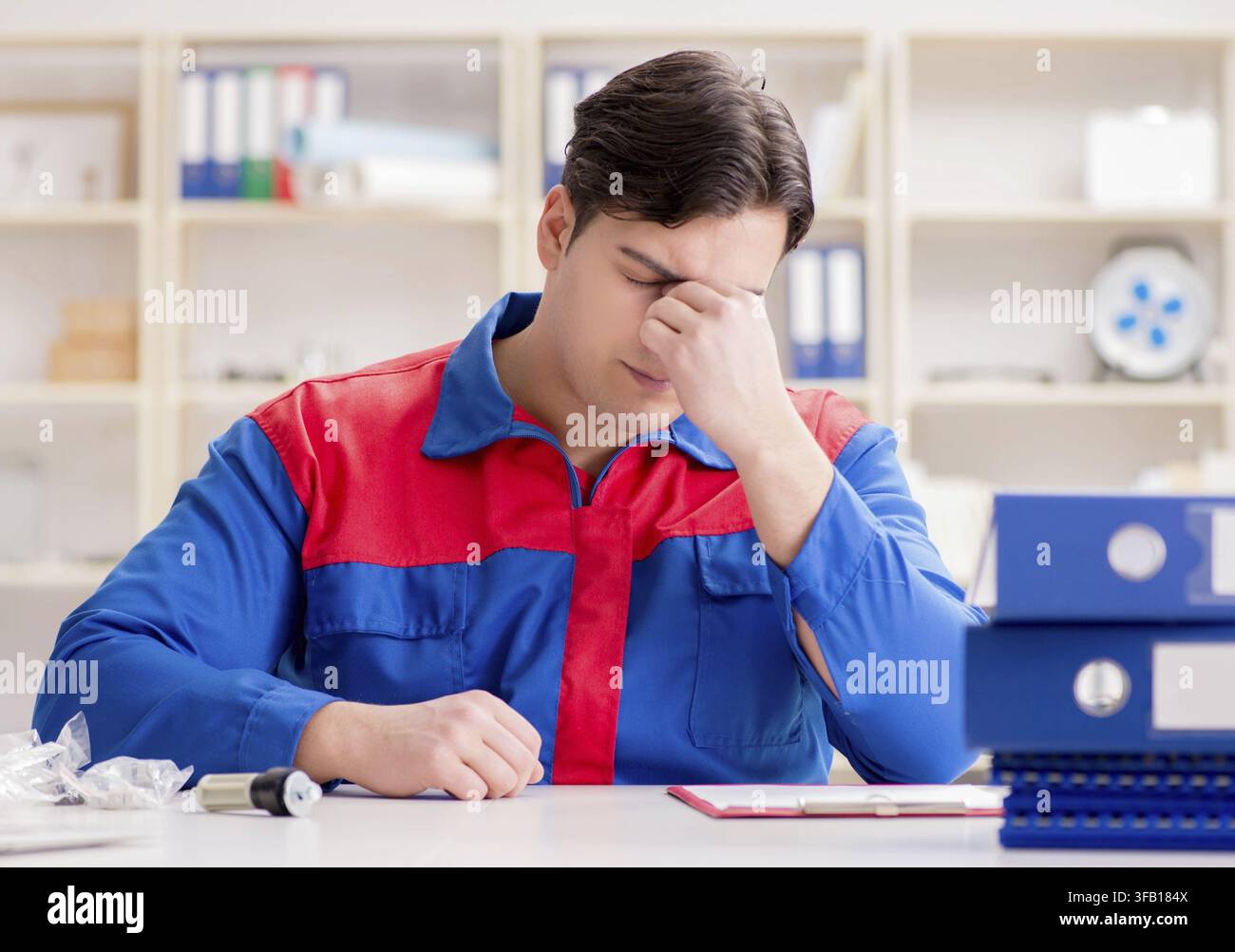 The worker in uniform is working on the project Stock Photo