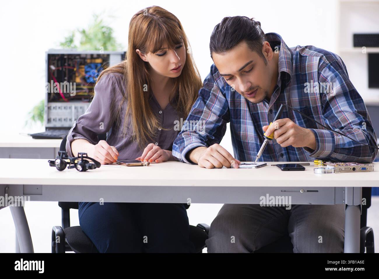 The two technicians who work in the computer warranty center Stock Photo