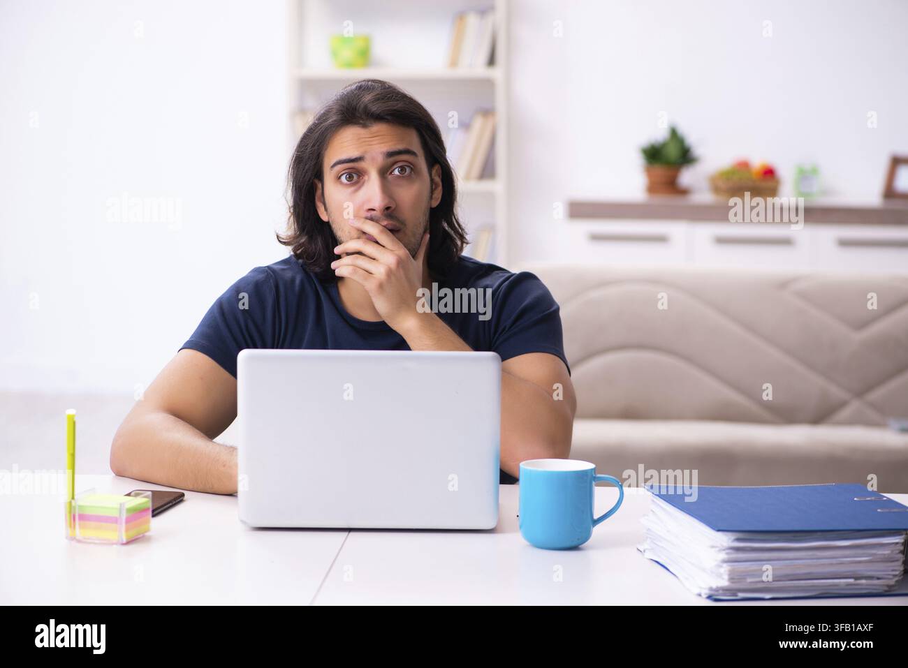 Young employee working from home Stock Photo