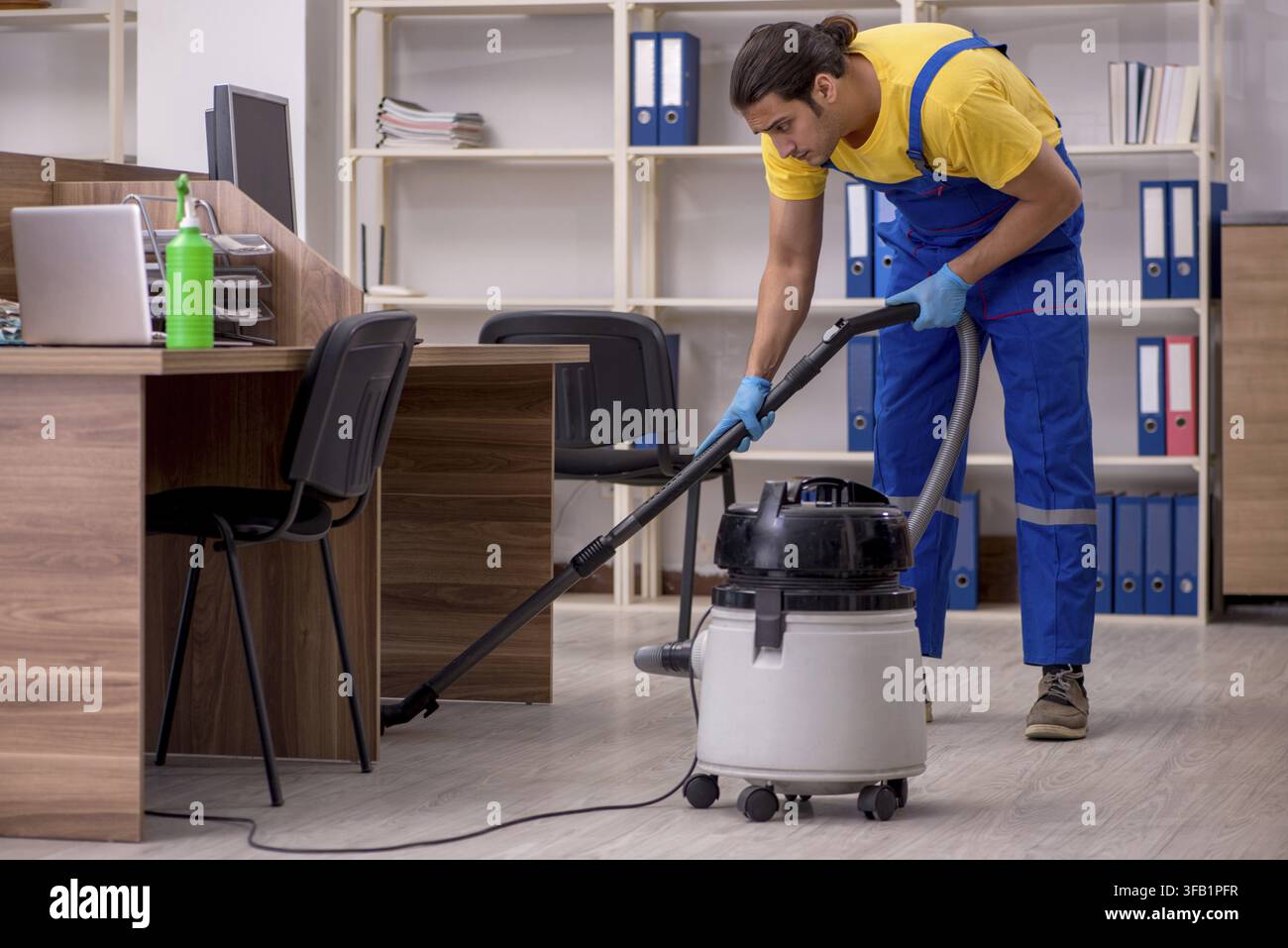 Male contractor cleaning office Stock Photo