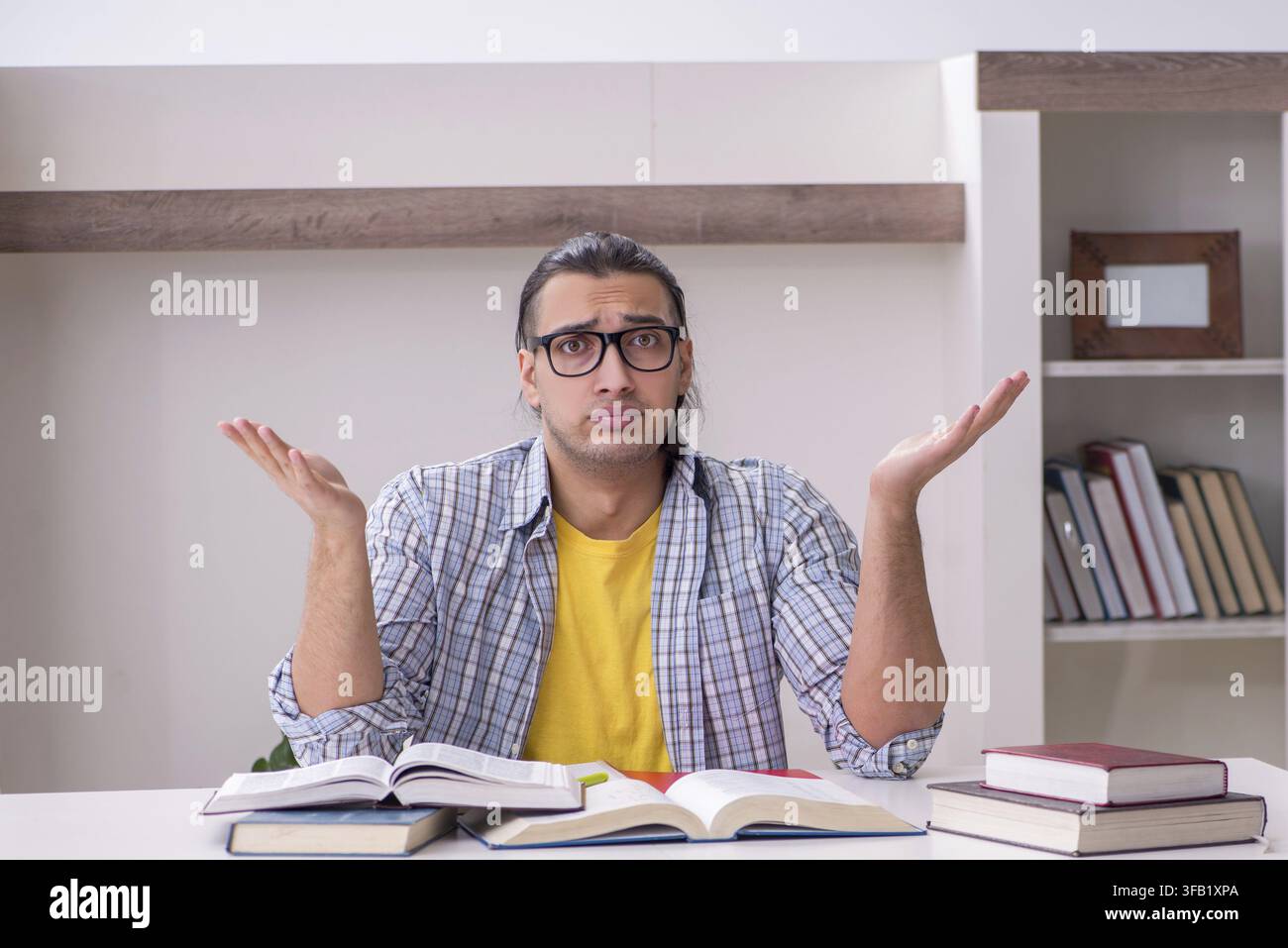 Male student preparing for exam at home Stock Photo