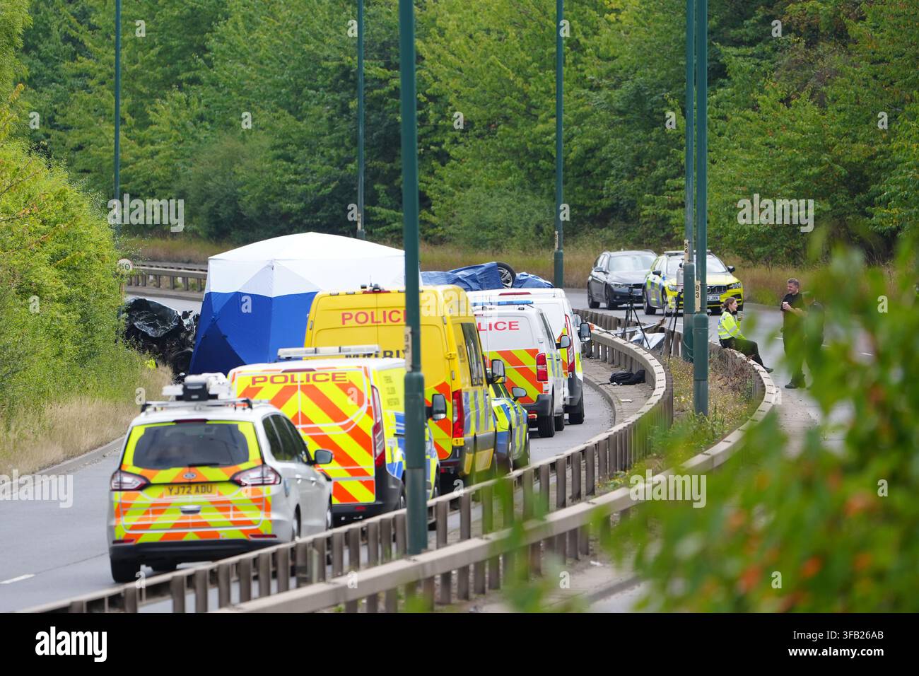 Police officers at the scene of a fatal crash involving a police car and a Volkswagen Passat on the A66 in South Bank, near Middlesbrough. An investigation has been launched into a crash which killed several people following a police pursuit in the early hours of Saturday morning, the police watchdog said. Picture date: Saturday August 22, 2026. Stock Photo