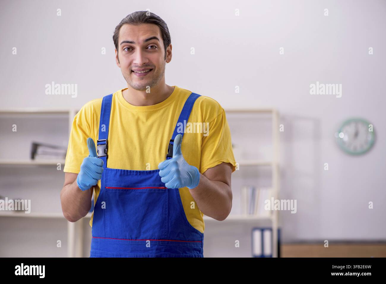 Male contractor cleaning office Stock Photo
