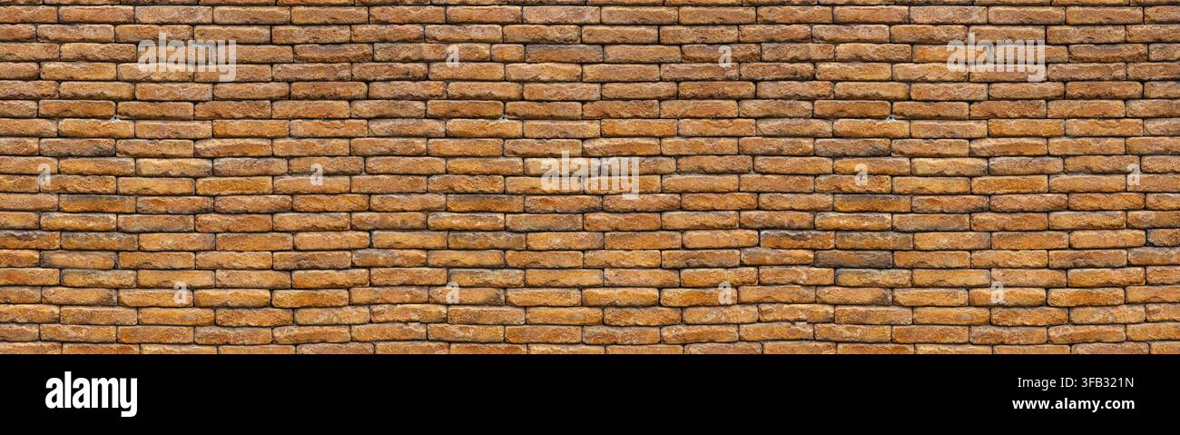 Old brown brick wall displaying a textured pattern for construction backgrounds Stock Photo