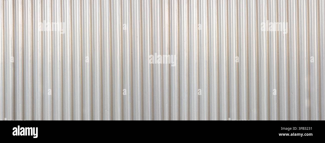 Corrugated metal wall panel forming a light texture and striped pattern Stock Photo