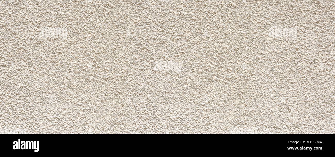 Stucco wall presenting a rough textured surface pattern Stock Photo