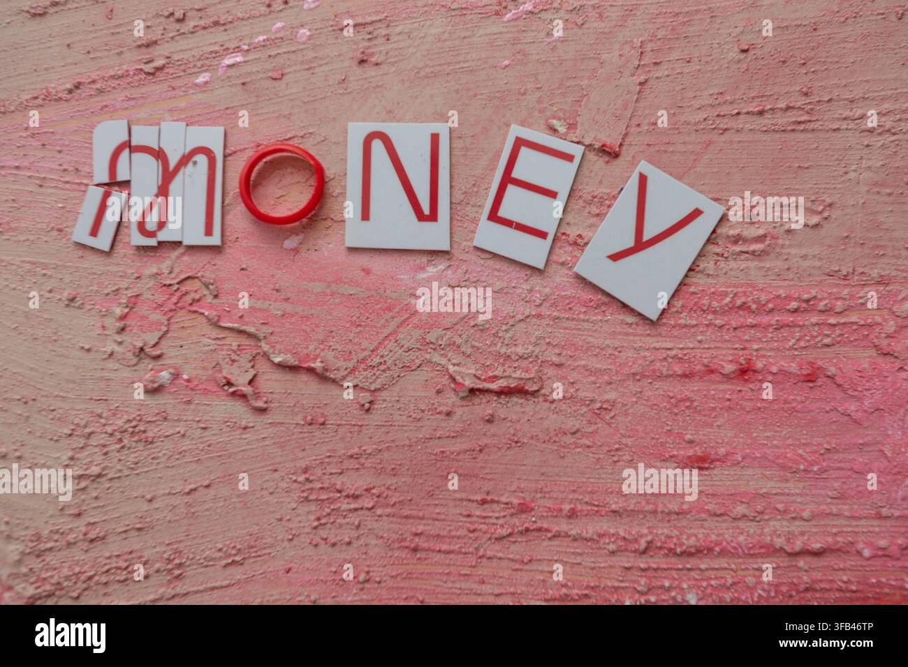 Against a textured red background a Virgin Money Mastercard credit card has been cut in to pieces perhaps too enthusiastically but tidily arranged. Stock Photo