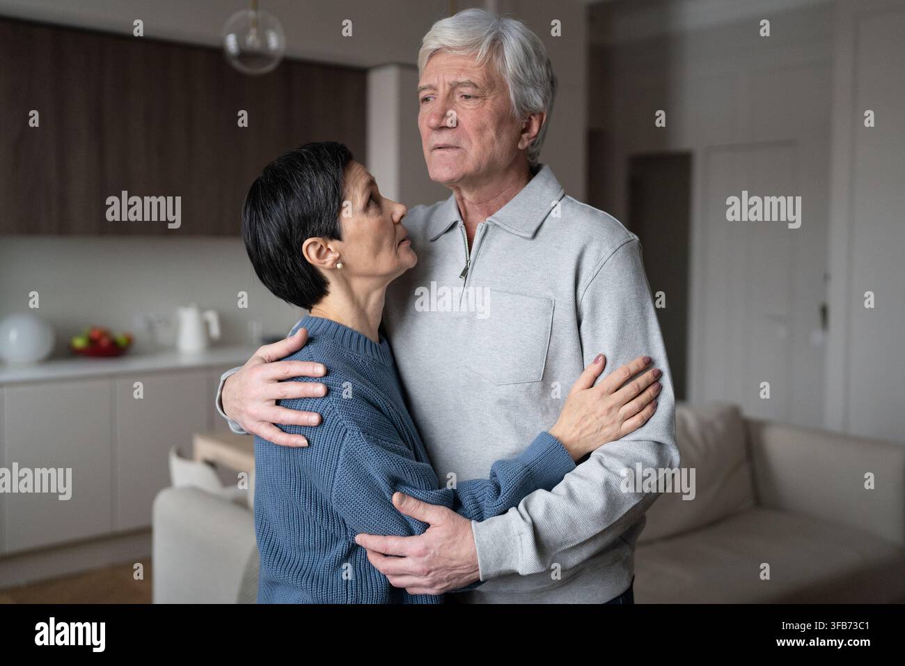 Senior anxious couple embracing comforting each other. Love support, health issues, emotional bond Stock Photo