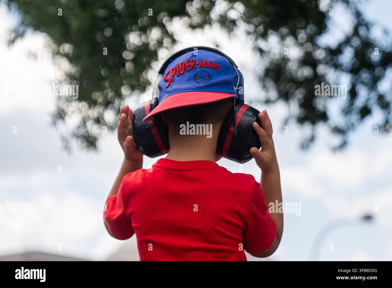 A child puts his hands over his headphones during the IndyCar Freedom ...