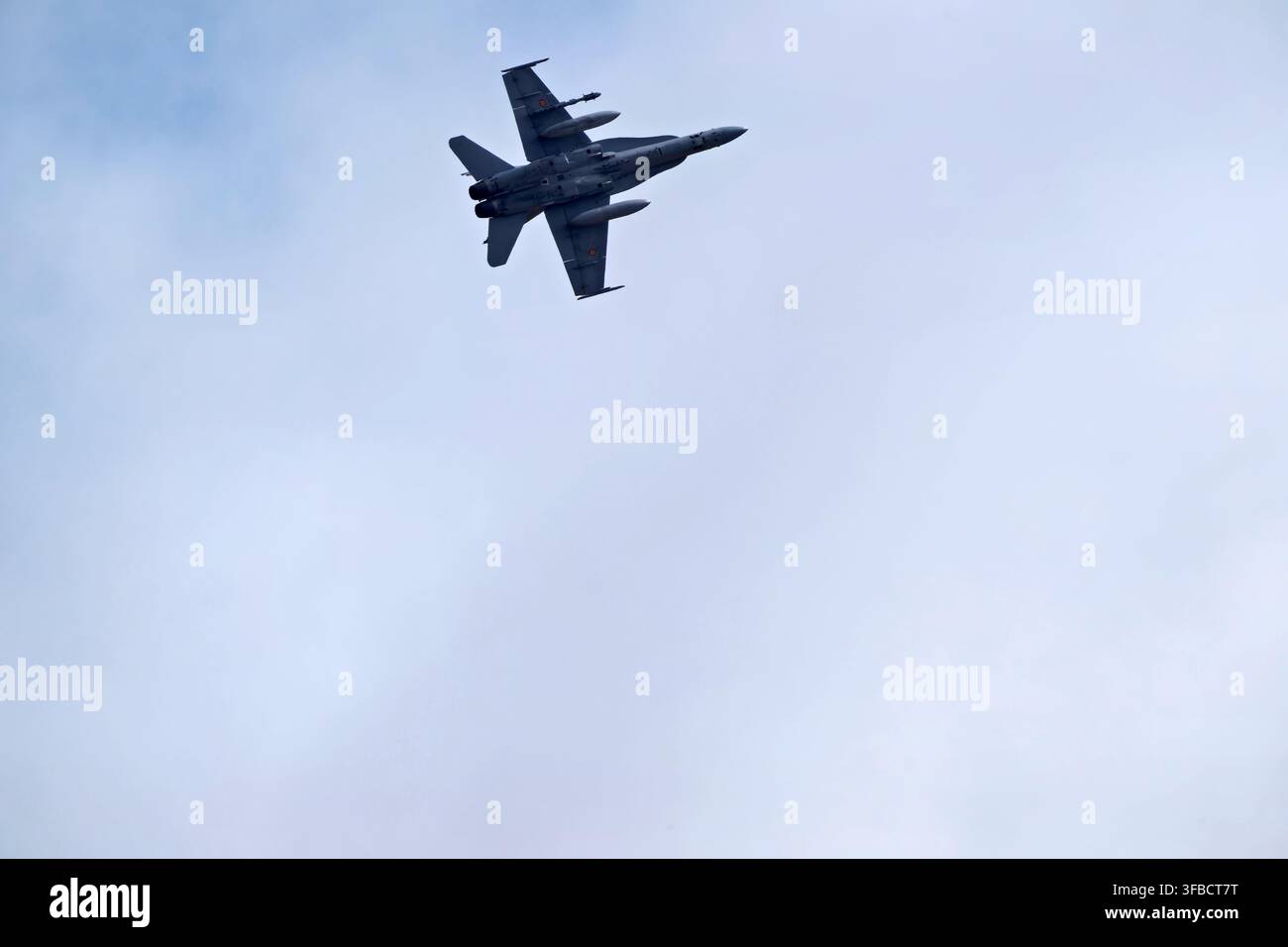 Fighter jet flying in cloudy sky. Stock Photo