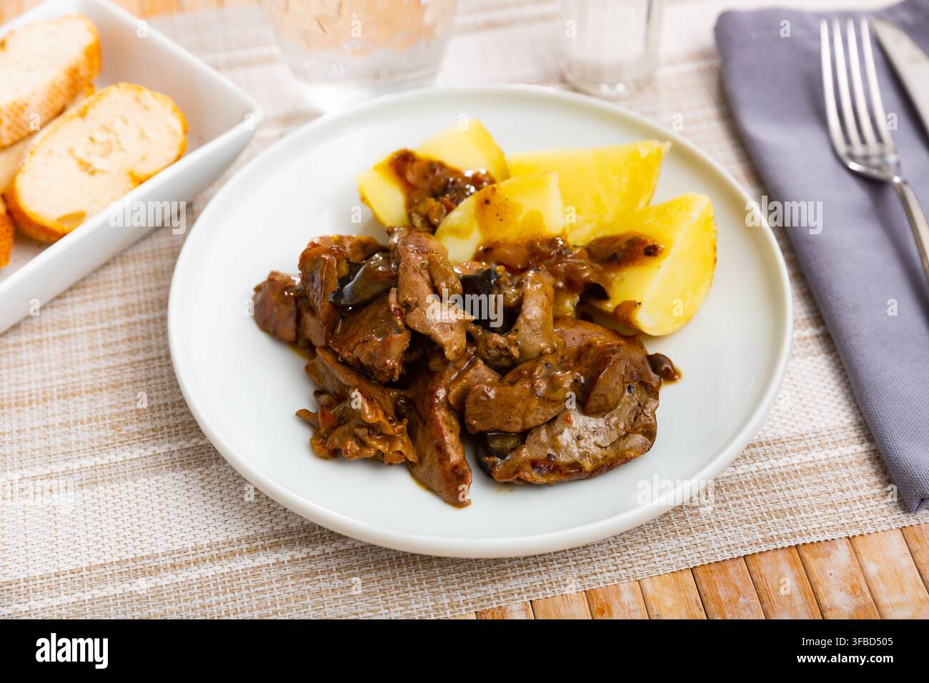 Fried rabbit liver served with boiled potato Stock Photo