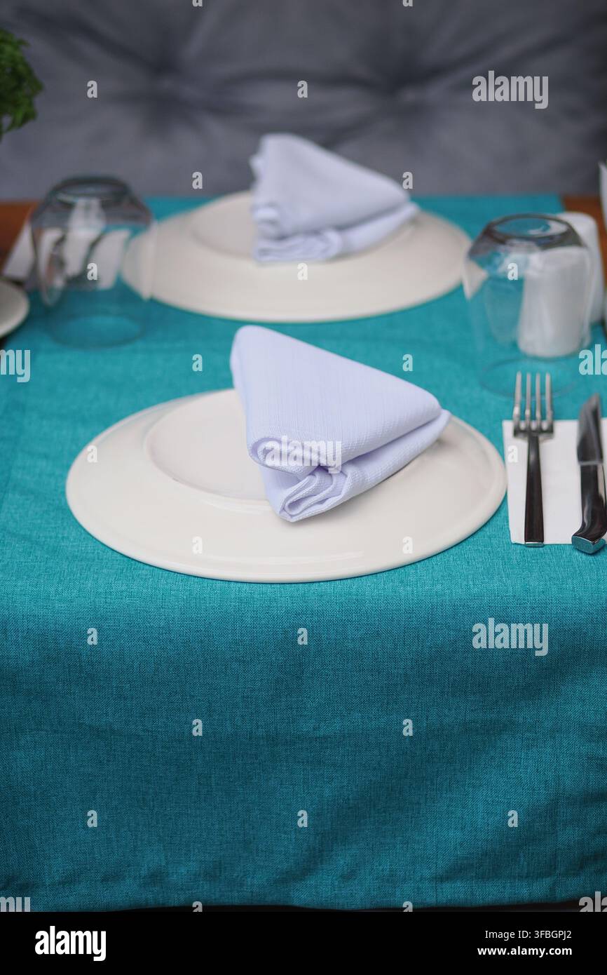 Table set for dining with cloth and utensils Stock Photo