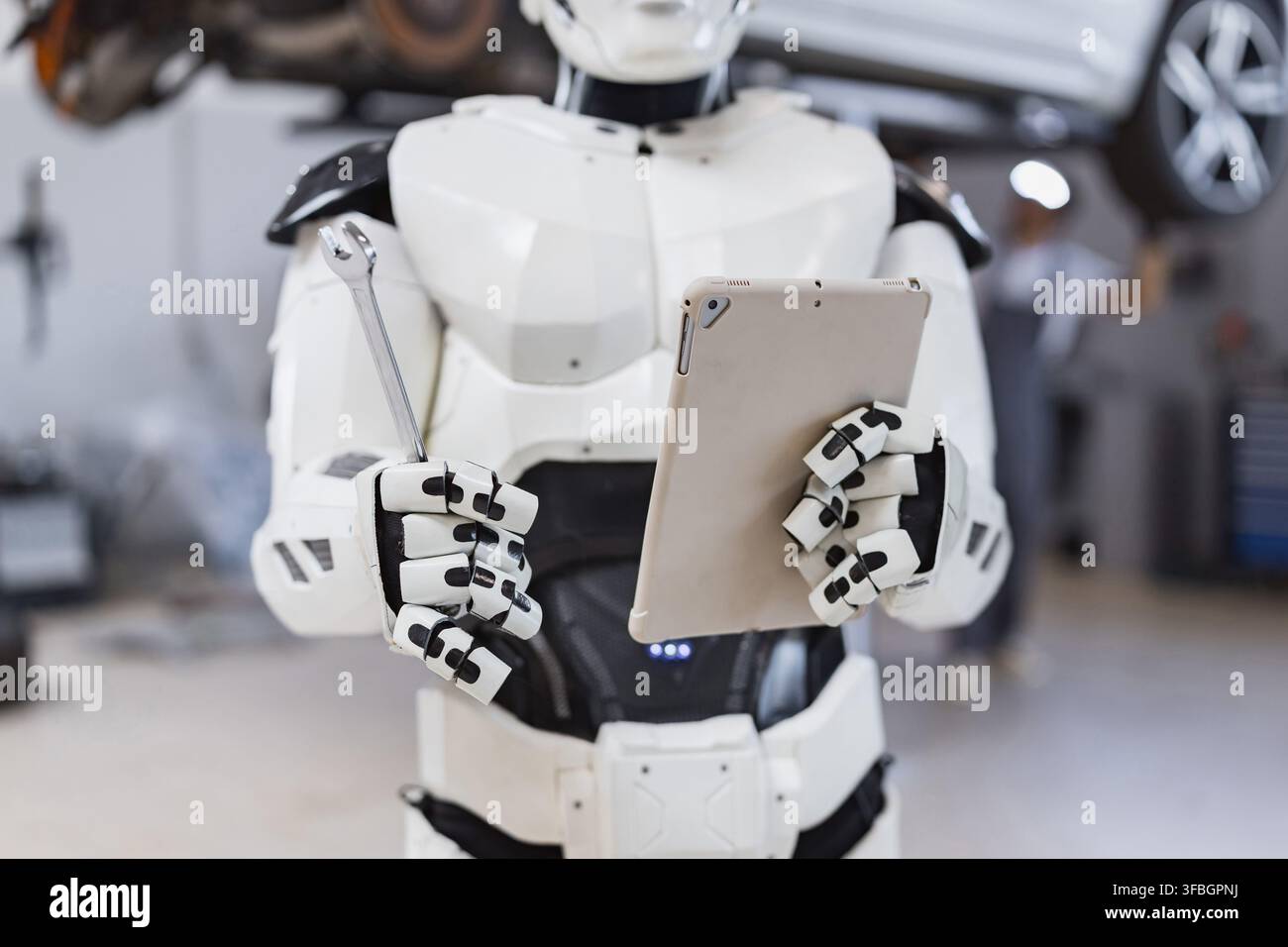 Robot Holding Wrench and Tablet Stock Photo