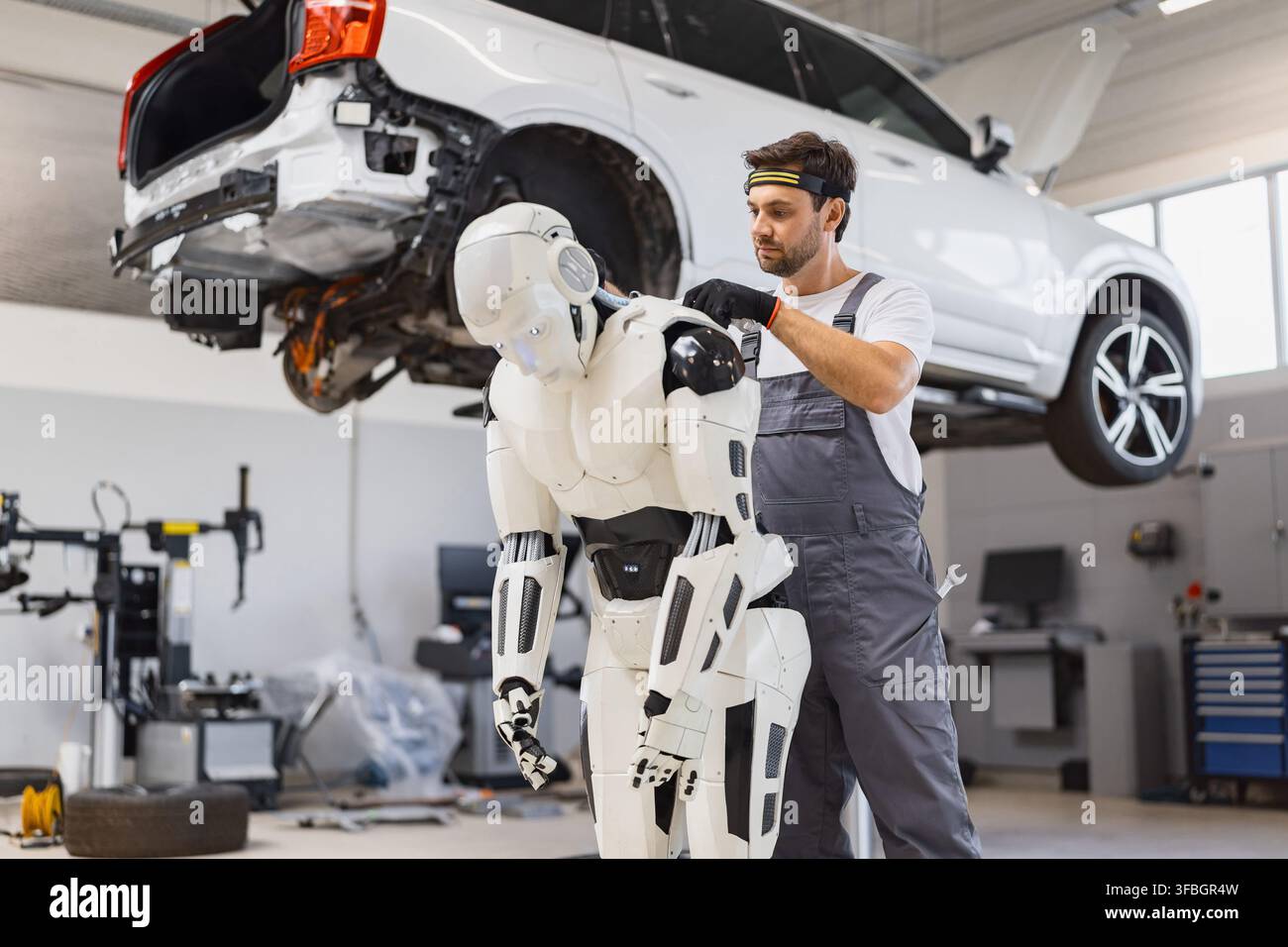 Mechanic Working On Robot Stock Photo