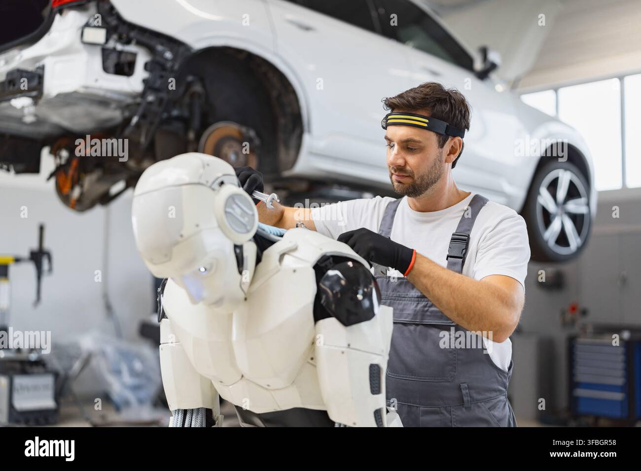 Mechanic Working On Robot Stock Photo