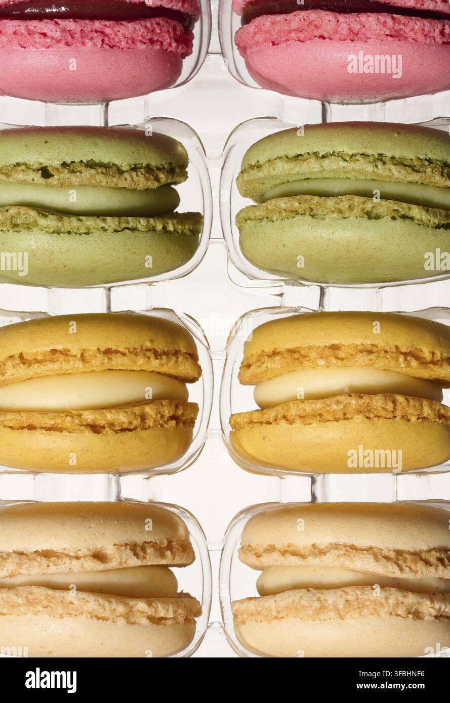 Macarons in plastic box on isolated background, top view Stock Photo