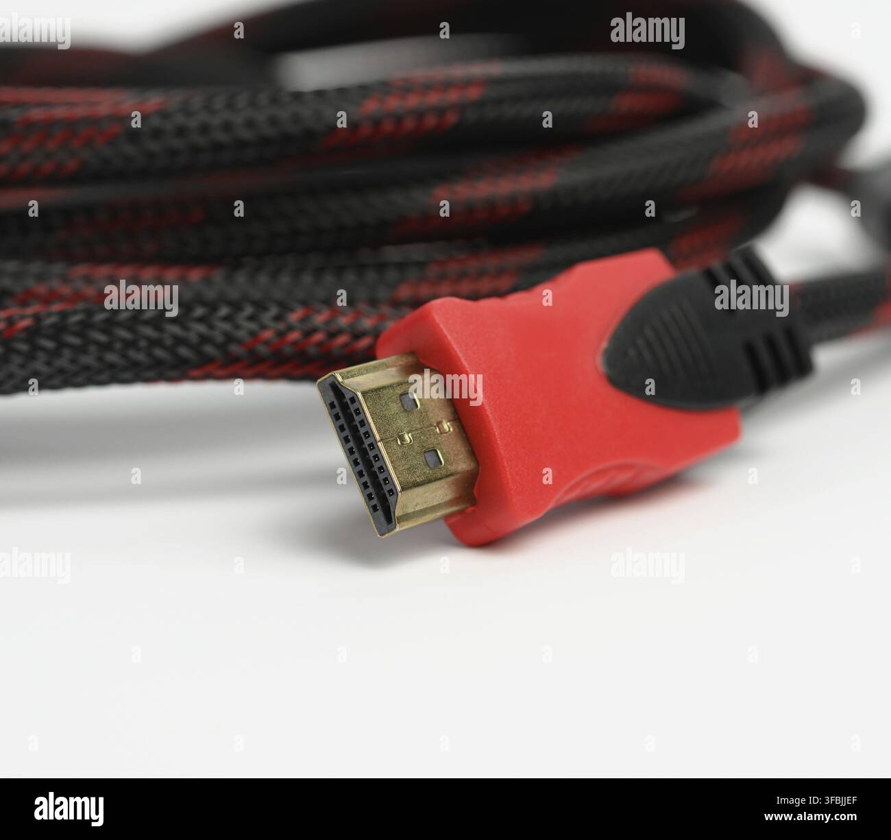 Twisted cable in a textile black sheath on a white background, hdmi adapter, macro Stock Photo