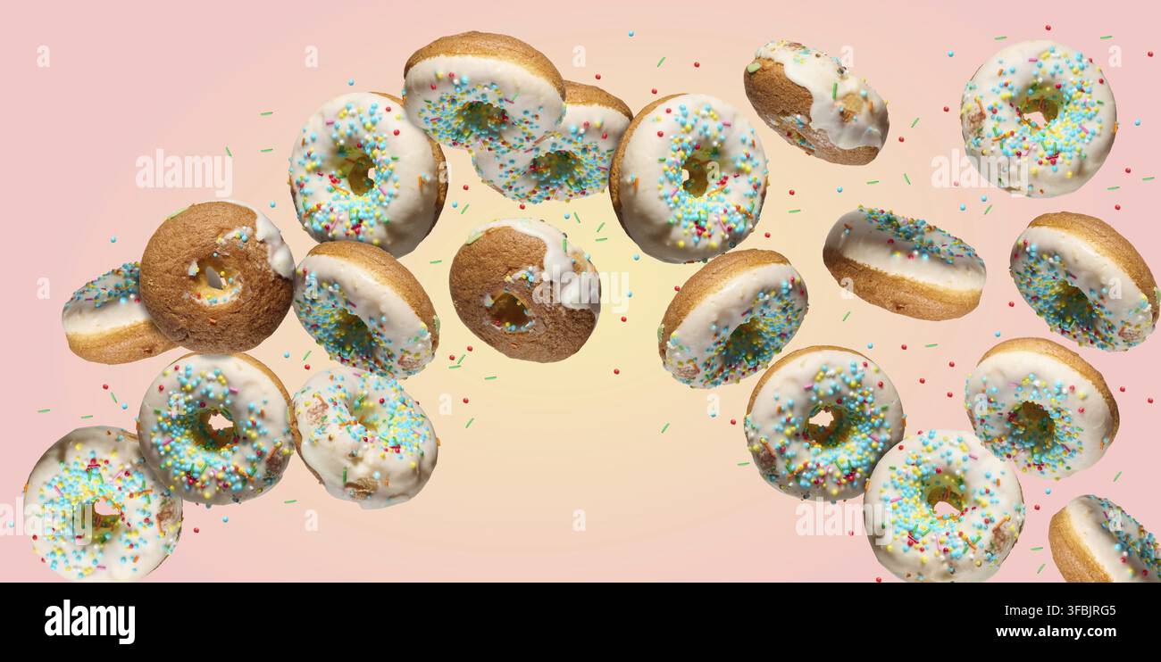 Multiple white glazed donuts with colorful sprinkles falling or flying in a curved path on a gradient pink and yellow background Stock Photo