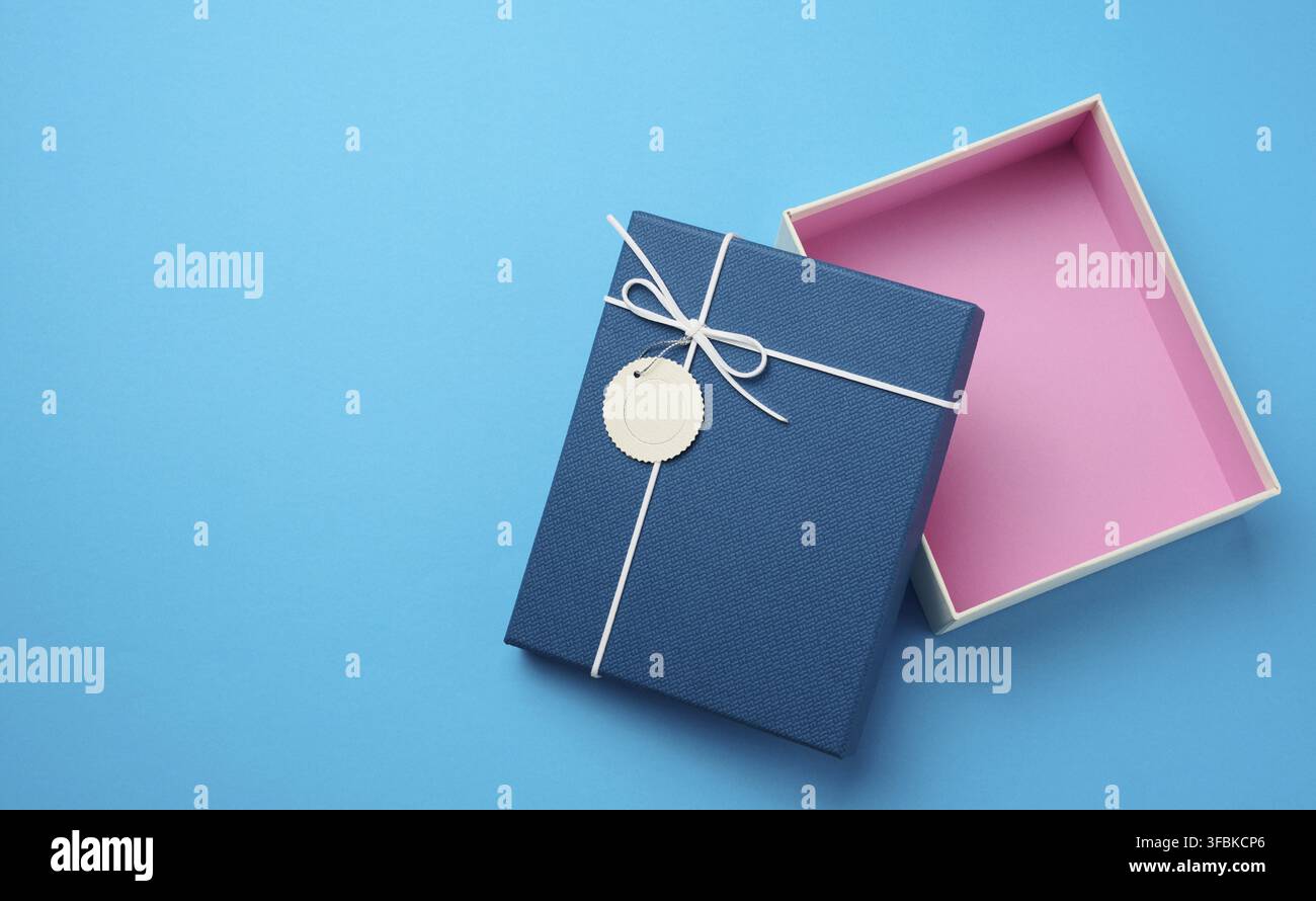 Empty open rectangular gift cardboard box on blue background, top view Stock Photo