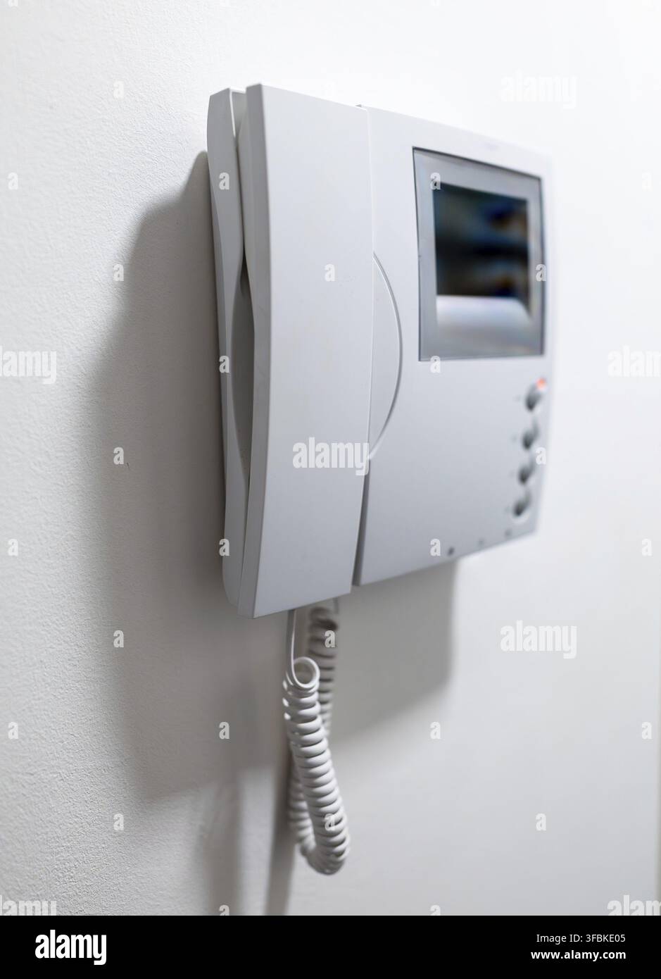 Modern Video Intercom System Mounted on white wall Stock Photo