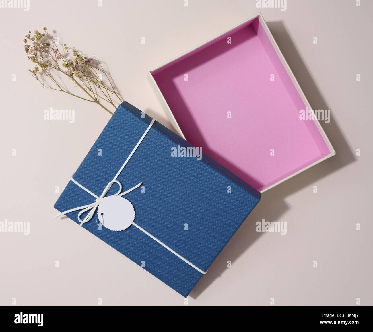 Empty open rectangular gift cardboard box on beige background, top view Stock Photo