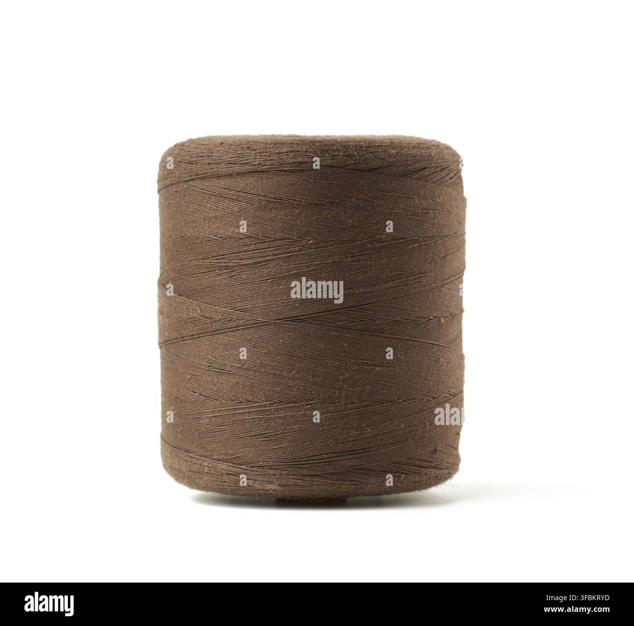 Large spool with brown cotton thread isolated on white background, close up Stock Photo