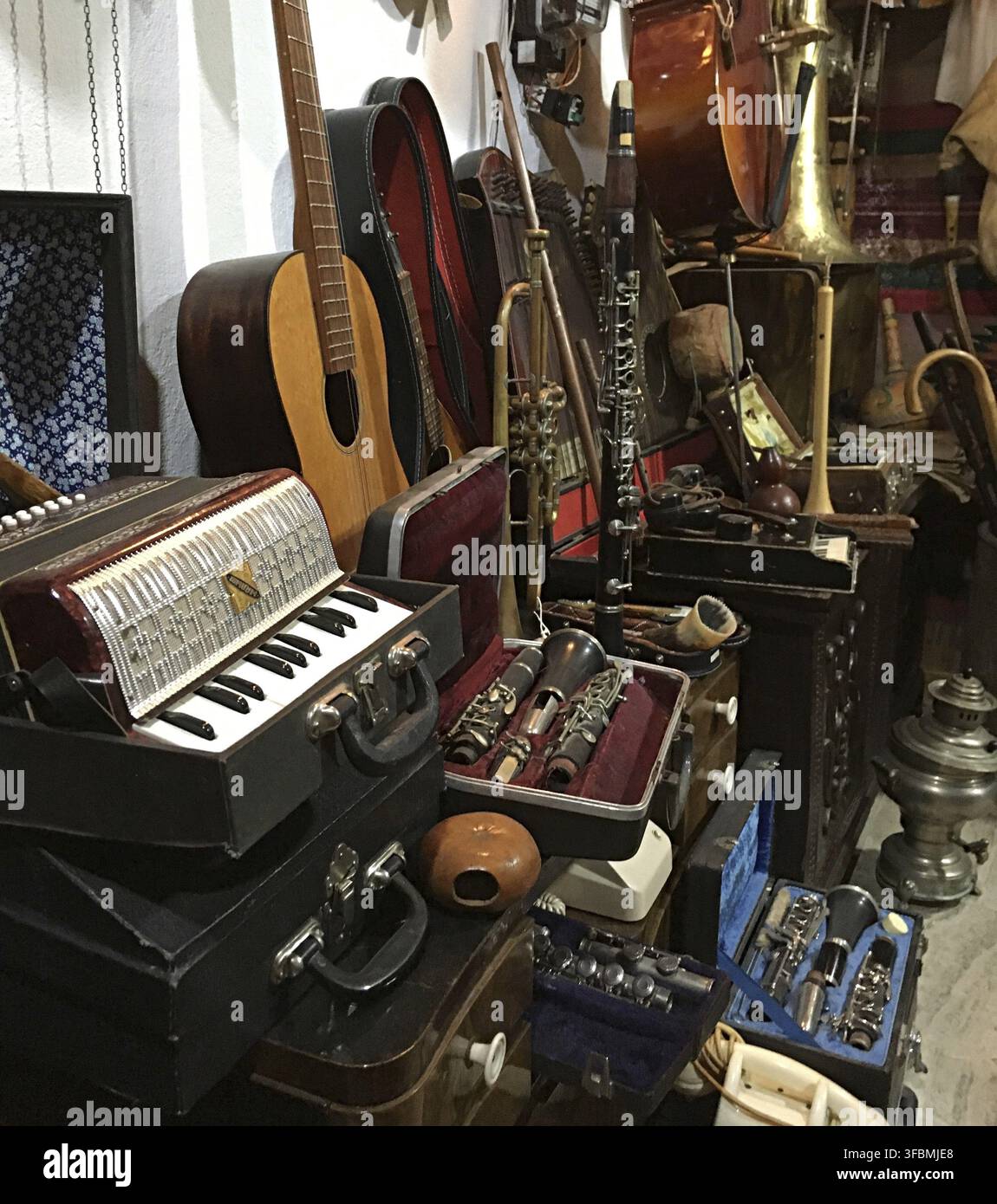 Close up of huge collection of vintage musical instruments in Antique shop Albania, Balkans. Stock Photo