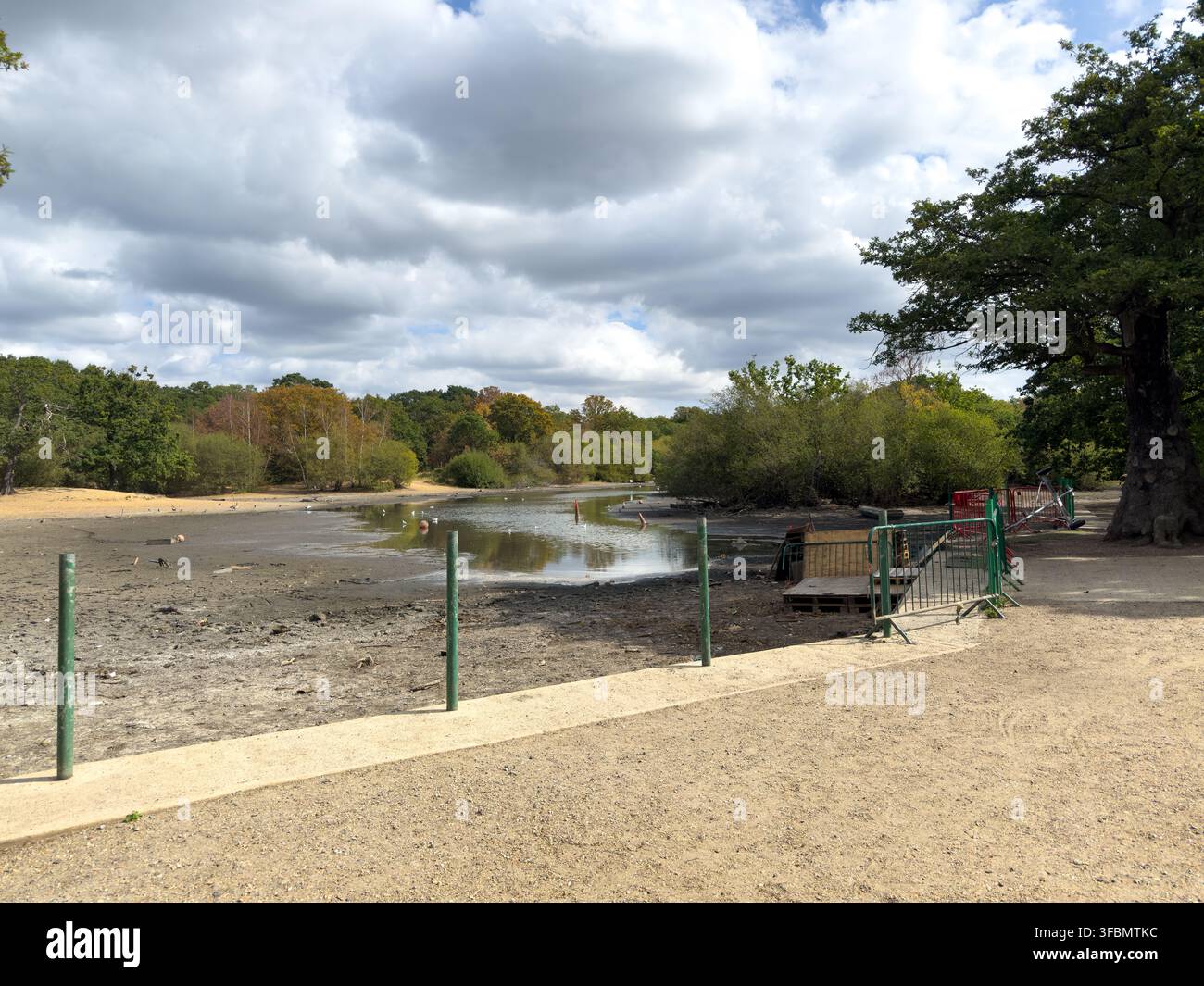 Hollow Ponds, Leyton Flats, Walthamstow, lies nearly dry following a summer heatwave, preventing the use of the popular boating area. - Smartphone Captured Stock Image