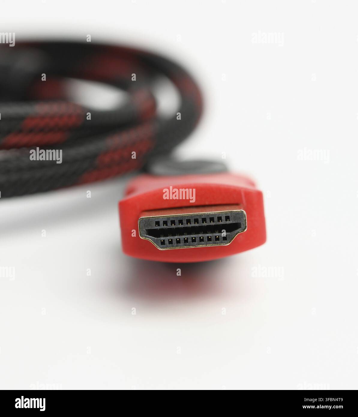 Twisted cable in a textile black sheath on a white background, hdmi adapter, macro Stock Photo