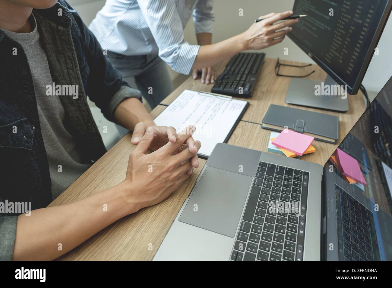 Collaborative work Software engineers website developer technologies or programmer working coding on startup ai application project on screen with par Stock Photo