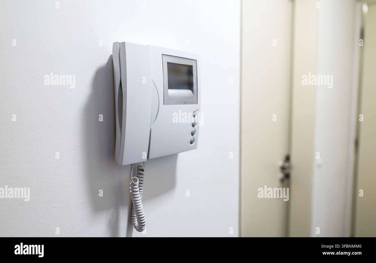 Modern Video Intercom System Mounted on white wall Stock Photo