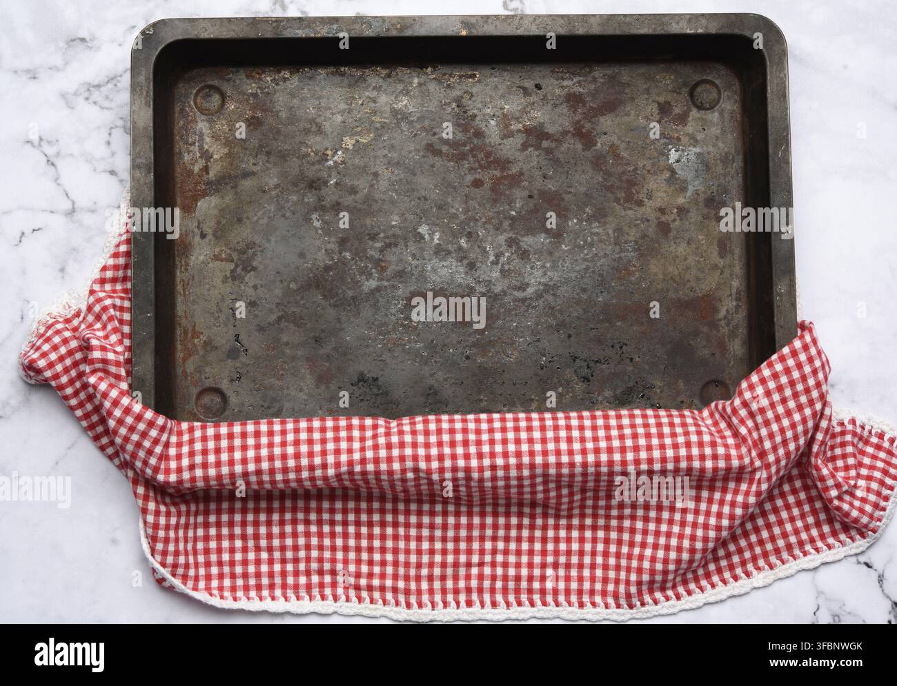 Empty rectangular iron baking sheet on white marble table, top view Stock Photo