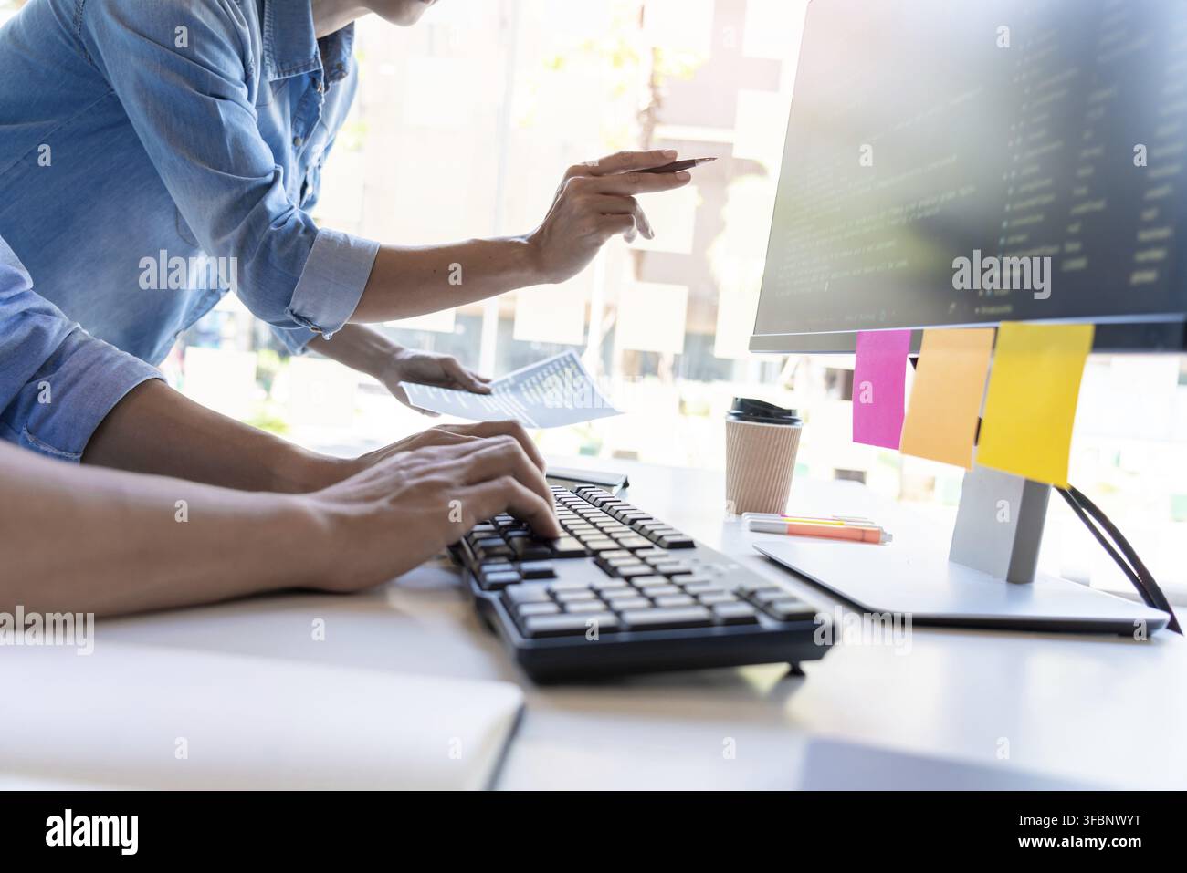 Pensive programmer working on on desktop pc programming code technologies or website design at office Software Development Company Stock Photo
