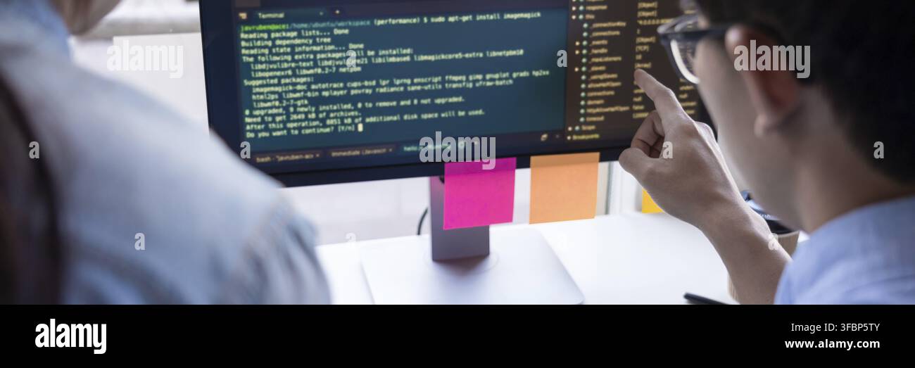 Young startup Programmers Sitting At Desks Working On Computers screen for Developing programming and coding to find solution to problem on New Applic Stock Photo