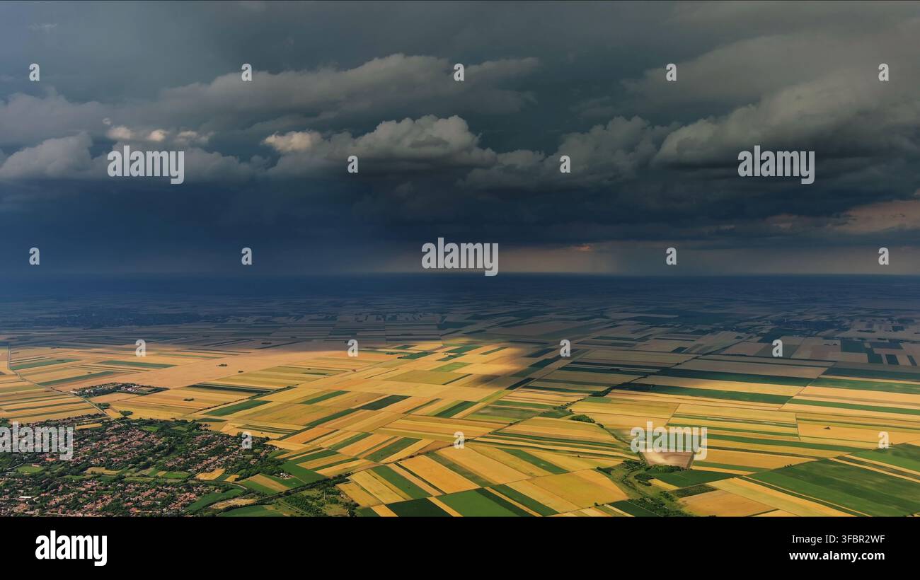 Agricultural fields under dramatic dark storm clouds Stock Photo