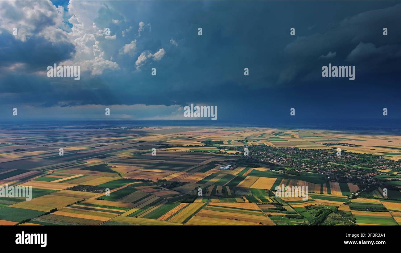 Agricultural fields under dramatic dark storm clouds Stock Photo