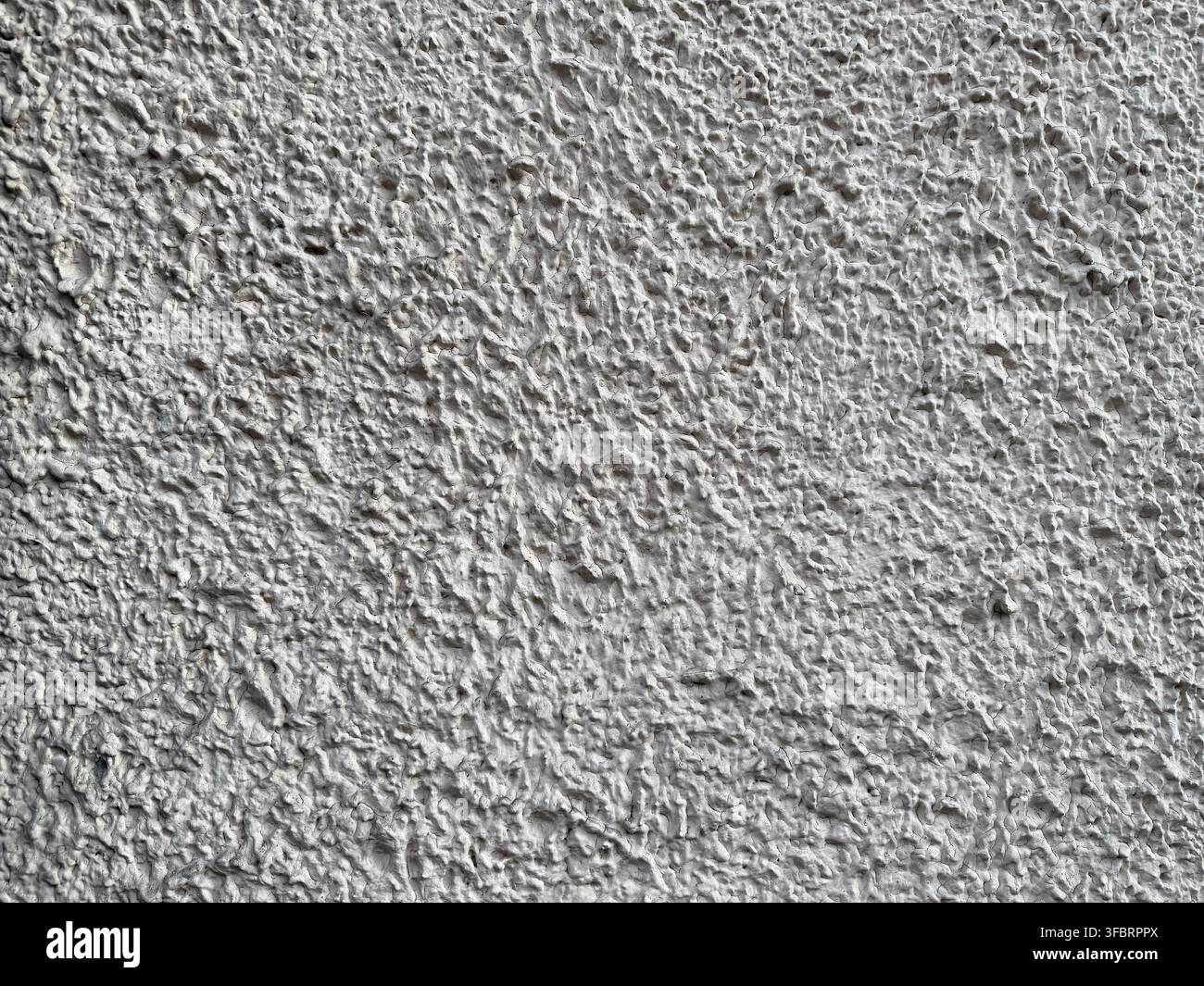 Textured gray roughcast plaster house wall Stock Photo