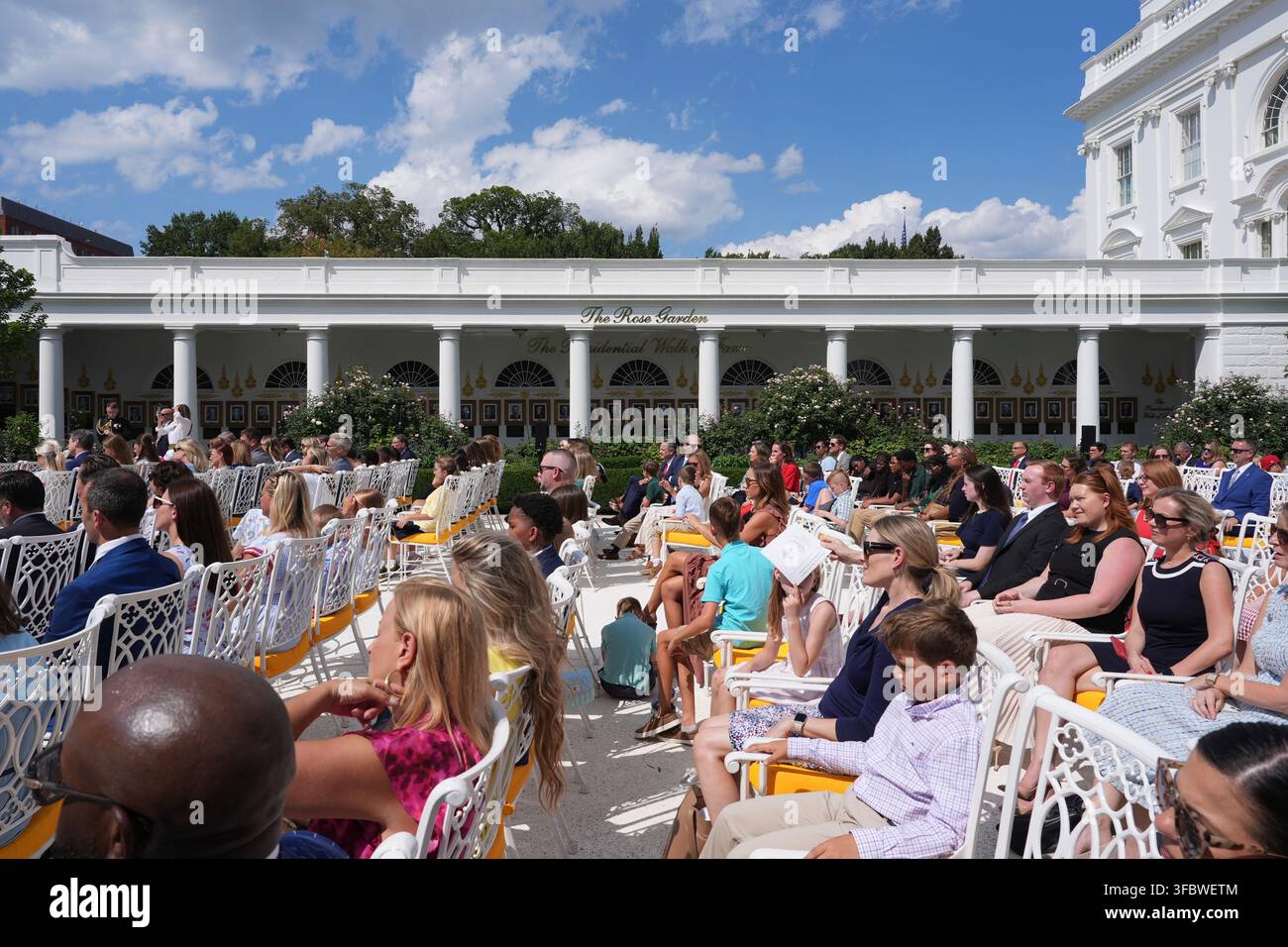 Guests listen as President Donald Trump speaks during a back to school ...