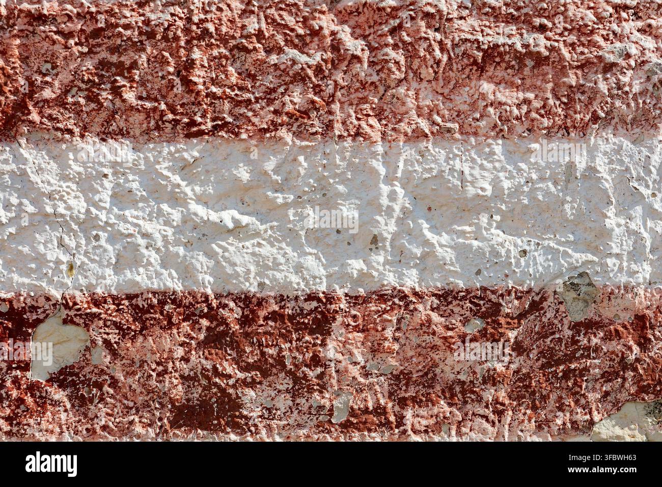 Weathered red and white striped wall texture background Stock Photo