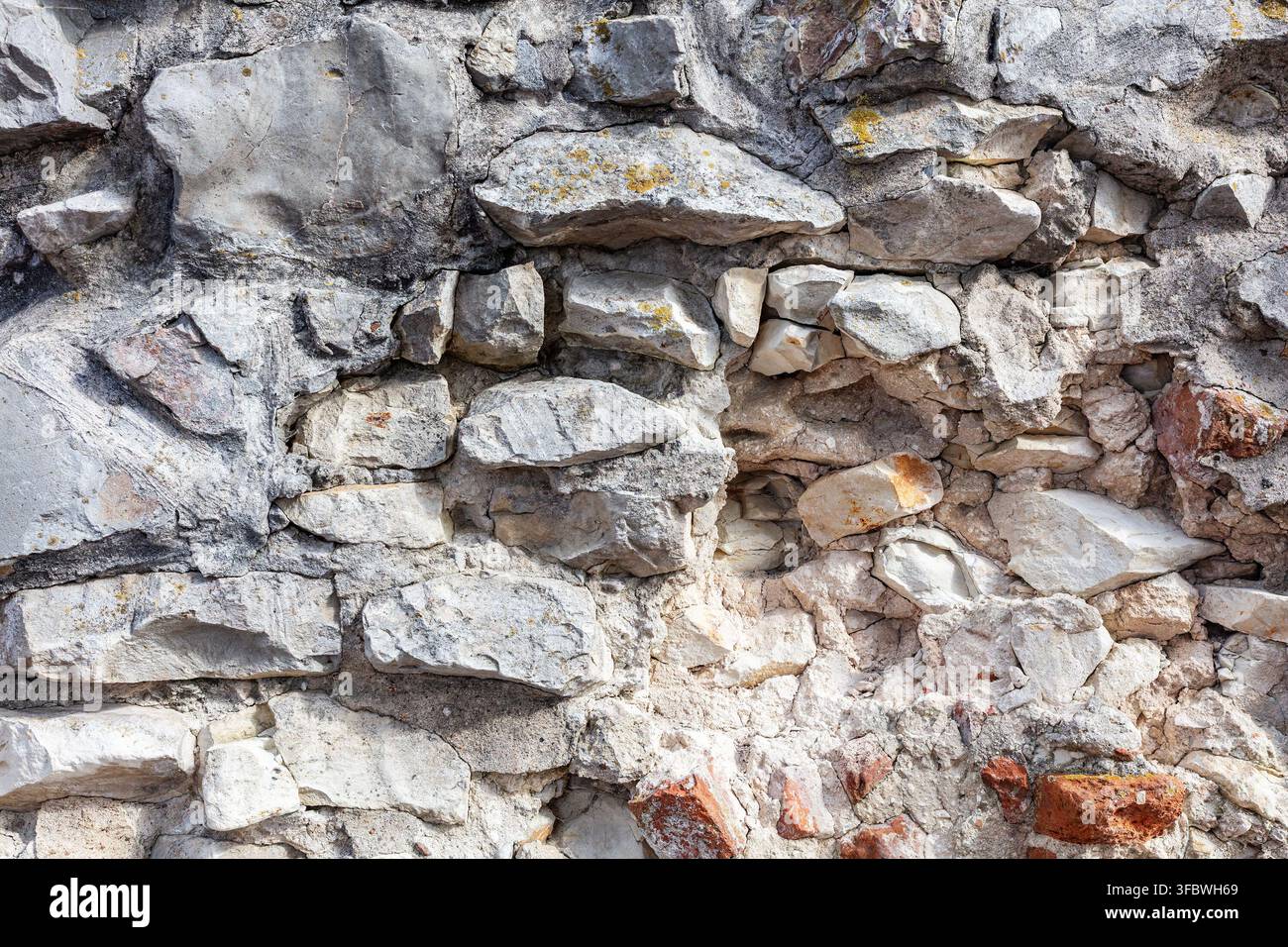 Rugged gray stone wall texture with rock blocks Stock Photo