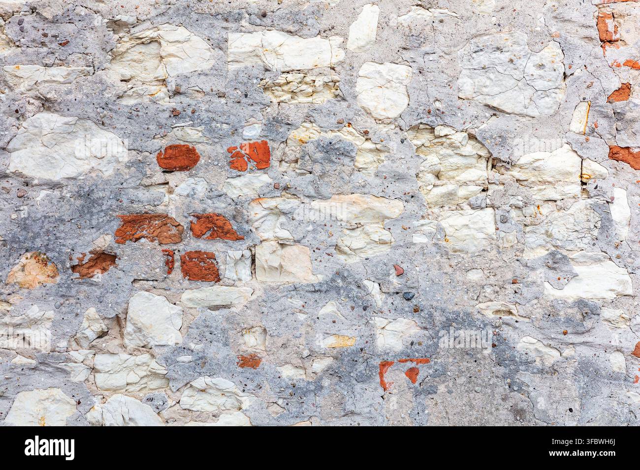 Old wall texture with exposed brick and crumbling plaster Stock Photo