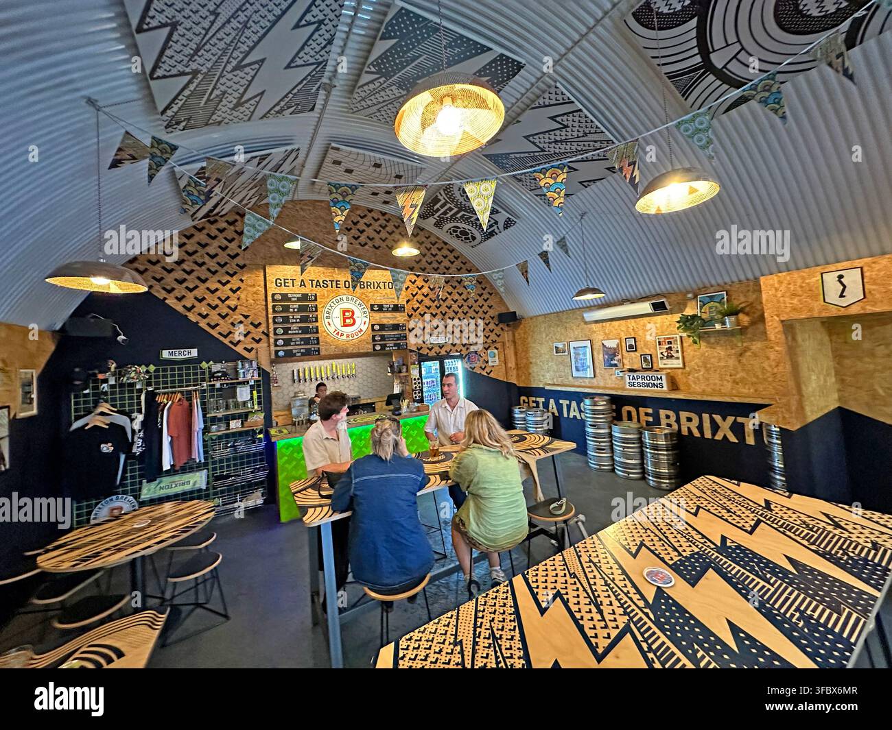 Interior of Brixton Brewery tap room in London, with customers drinking craft beer and ales. Stock Photo