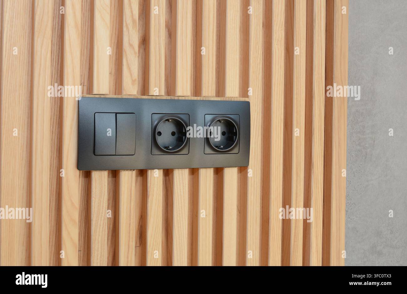 Electrical outlet light switch on wooden wall Stock Photo