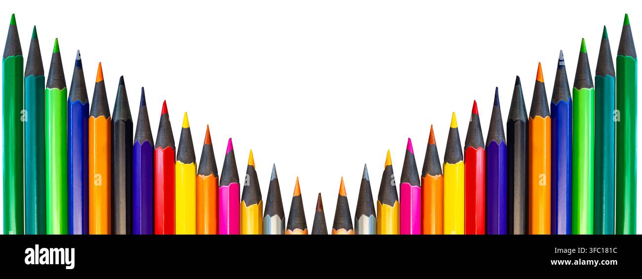 Pencils of various colors are arranged in a triangular pattern with sharp tips pointed upwards on a plain background. Stock Photo
